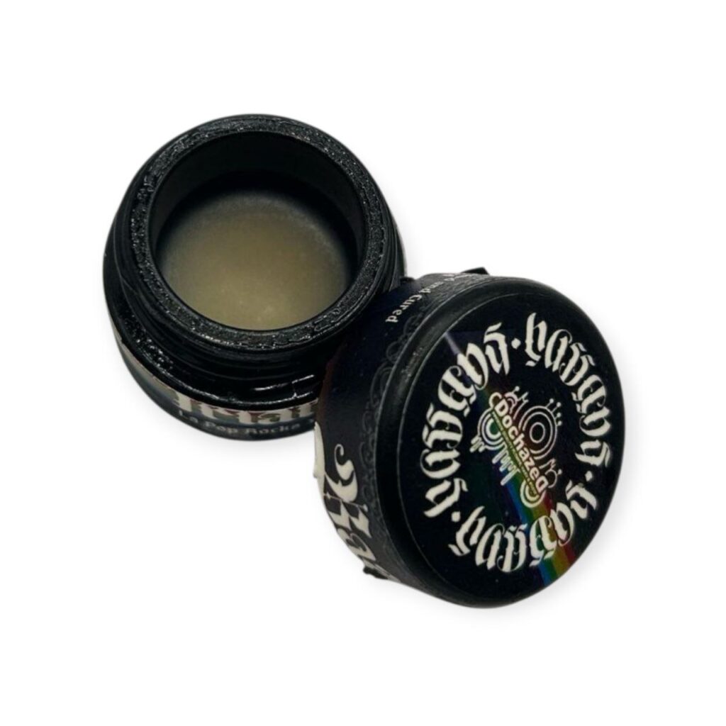 Award-winning Bask Triangle rosin jar from Hassans × Dochazed, featuring golden solventless extract in a 1g format